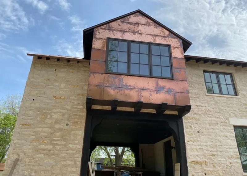 Copper metal panel facade on a stone building for Skylight Installation in Jeffersonville
